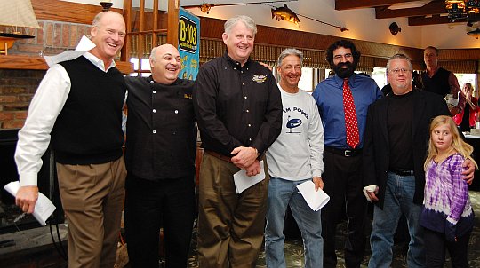 6 men standing in a rustic restaurant