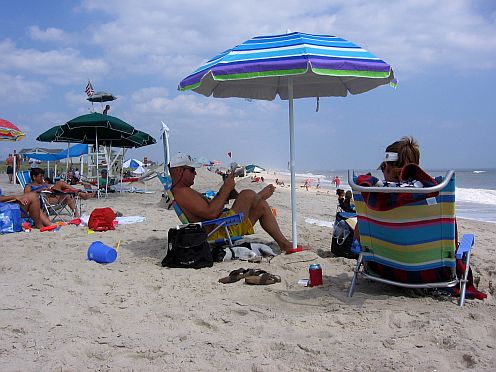 sitting under a beach umbrella