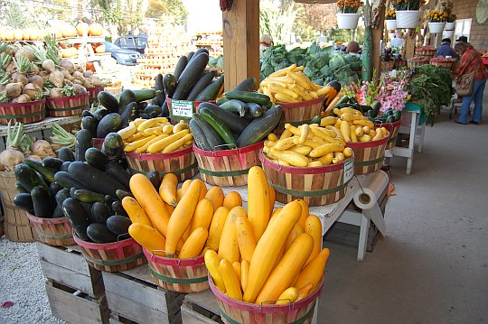 vegitables in baskets at an open air market