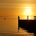 A golden sunrise over a dock on the great south bay.