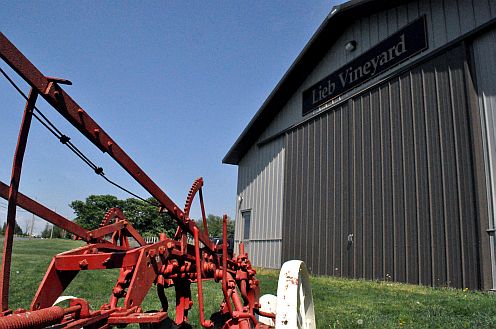 An old plow and modern barn