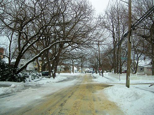 sand on a snow covered street