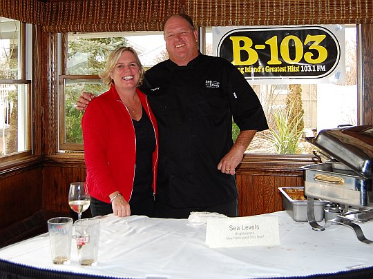 wife and husband standing behind a table