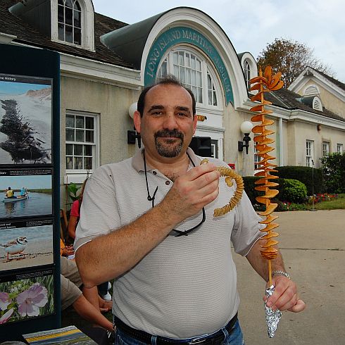 man holding egg case and tornado potato